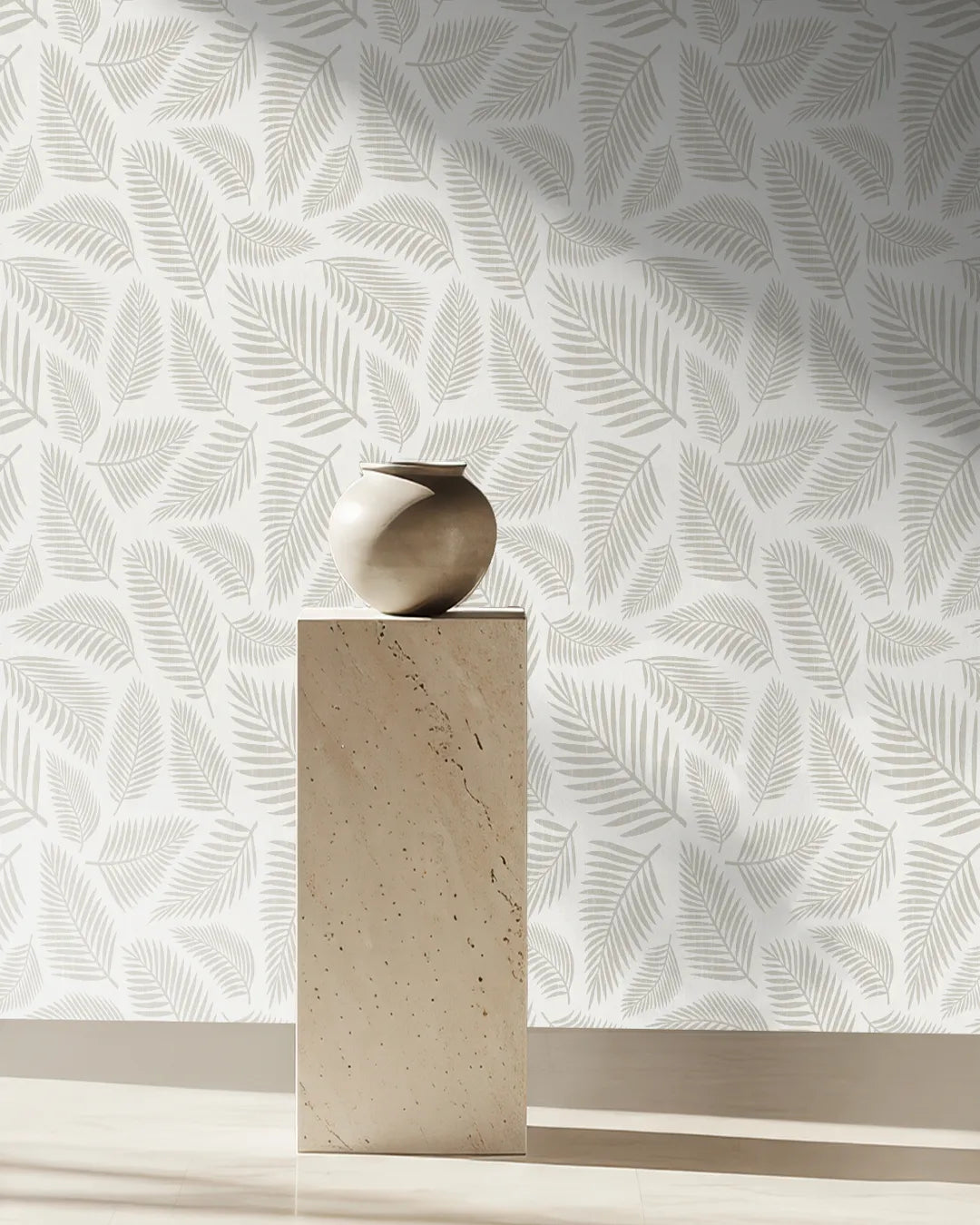 Decorative wall with leaf pattern by Buffalo Bunny and a vase on a pedestal