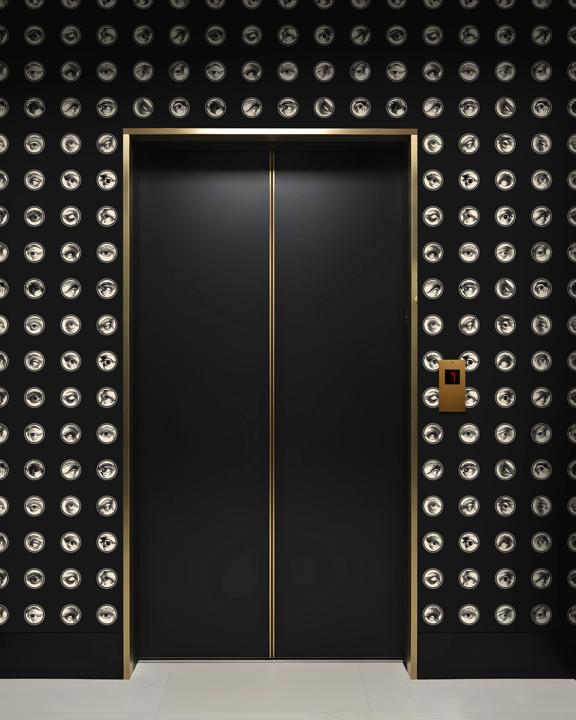 Black elevator with gold accents against eye wallpaper from Buffalo Bunny.