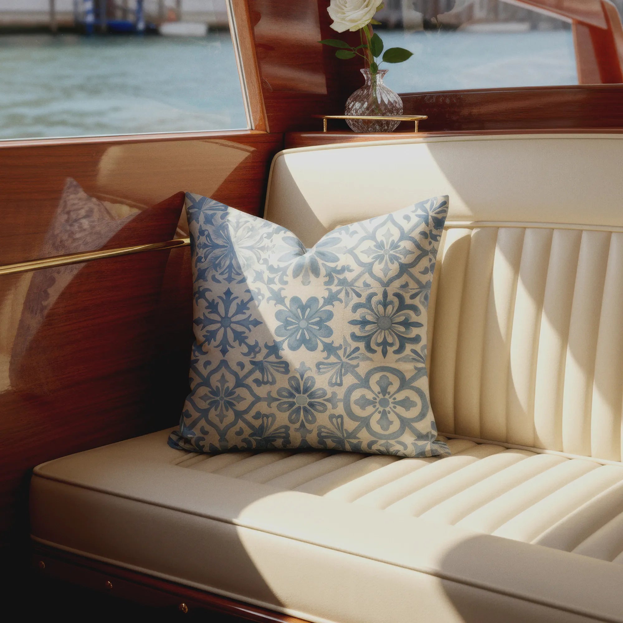 Decorative pillow on a boat seat with water view