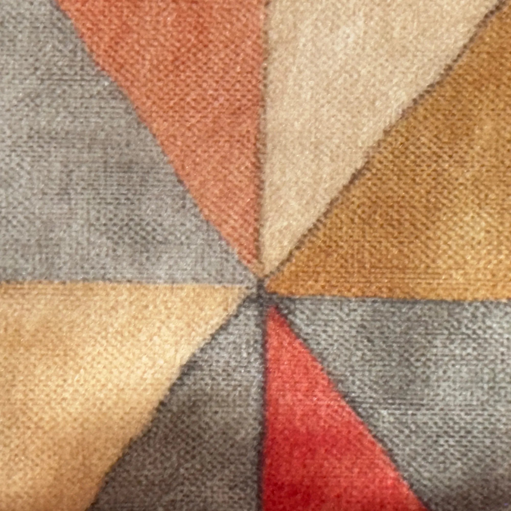 Close-up of a textured fabric with geometric pattern in earthy tones.