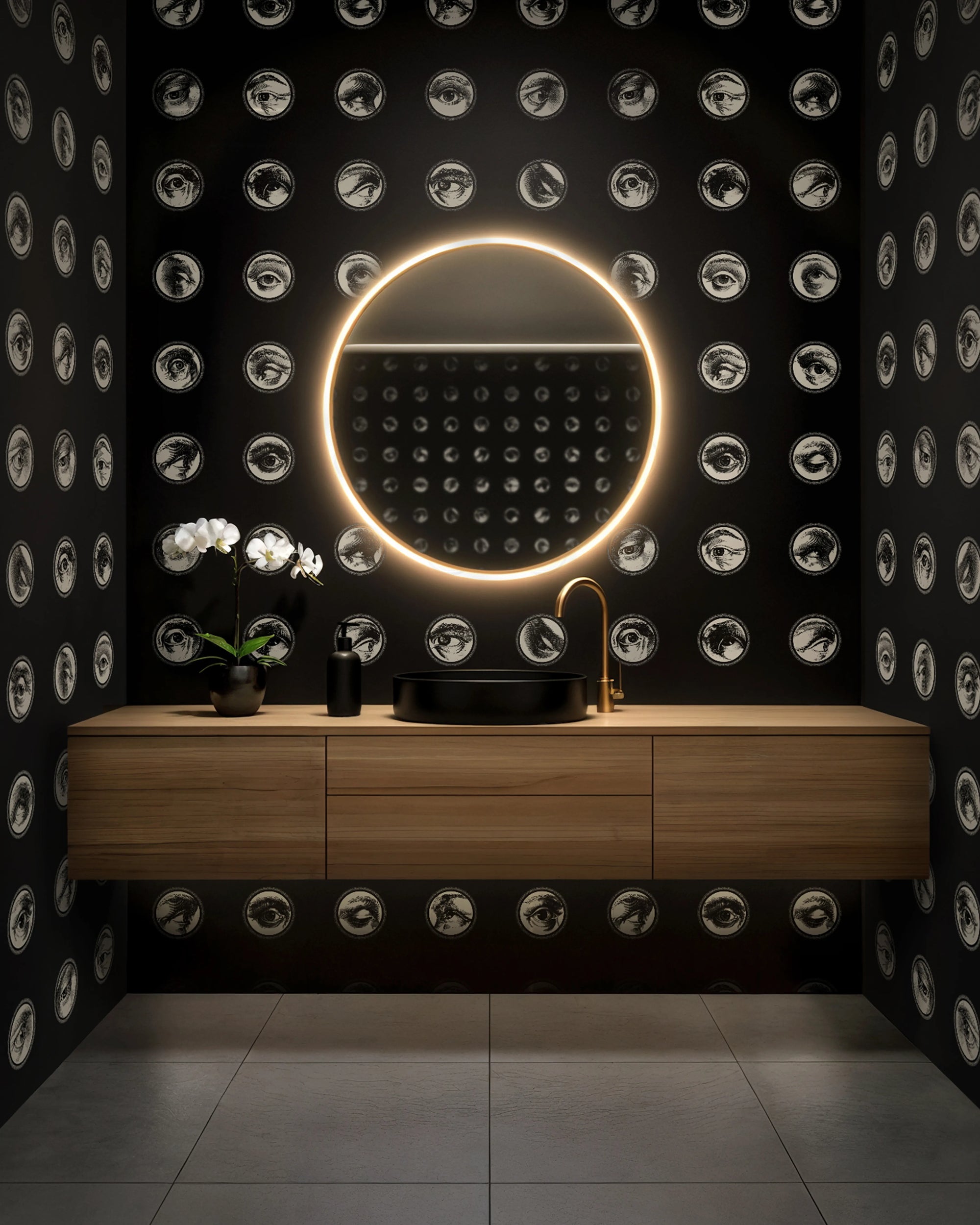 Modern bathroom with a round illuminated mirror and wooden vanity against a black wall with circular patterns from Buffalo Bunny.