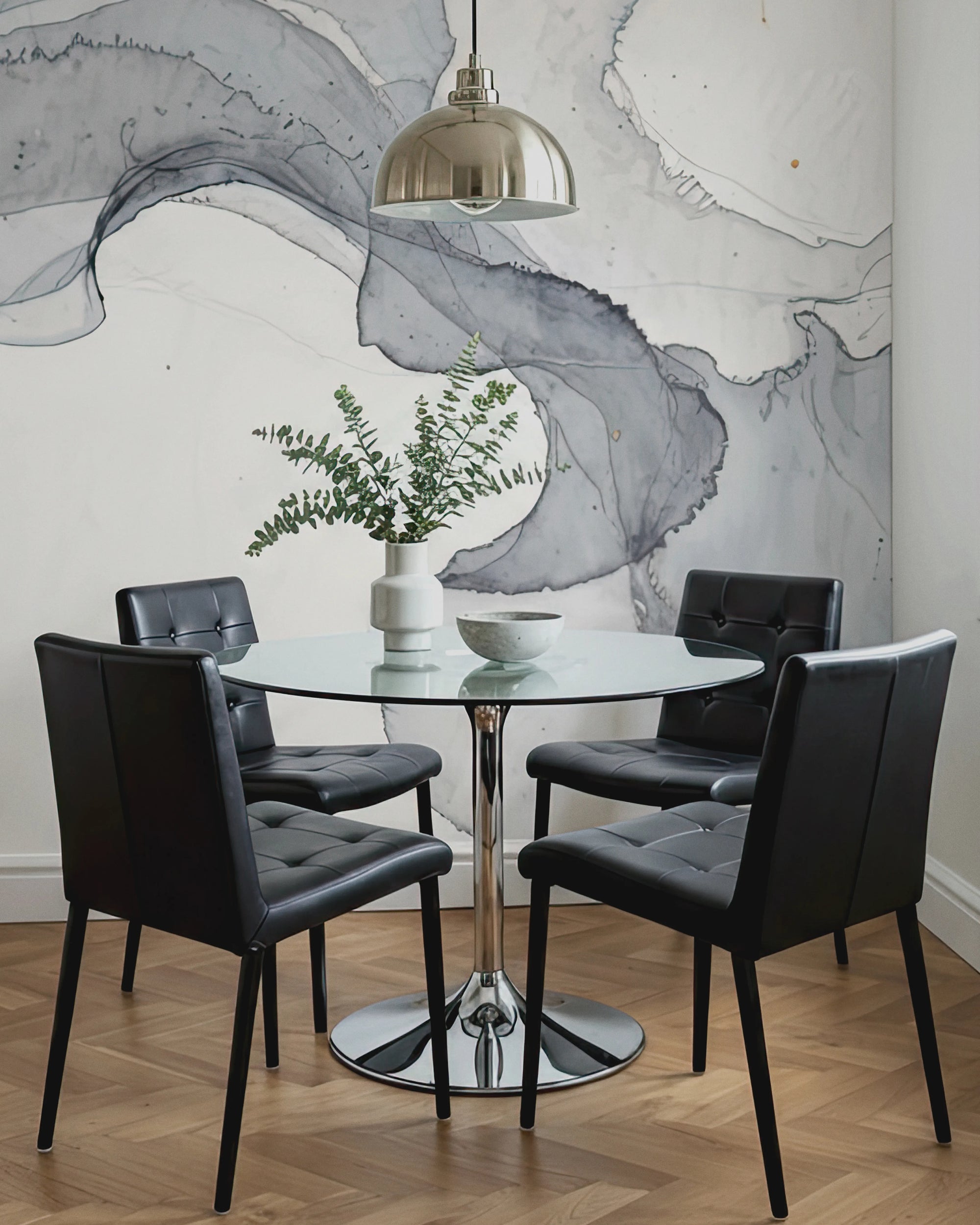 Dining room with a round glass table and black chairs against a decorative wallpaper Buffalo Bunny.