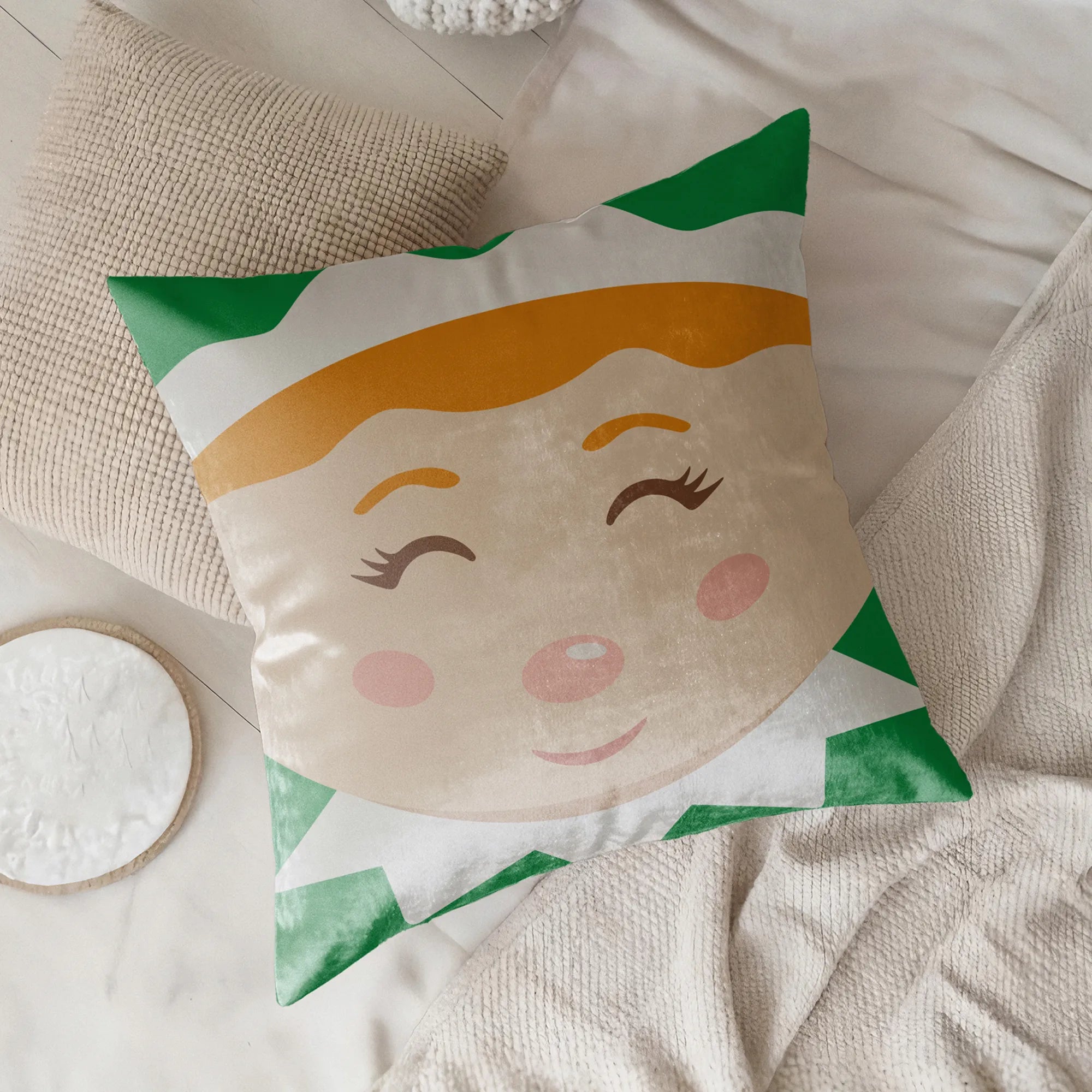 Decorative christmas pillow with a elf face design on a soft surface by Buffalo Bunny.