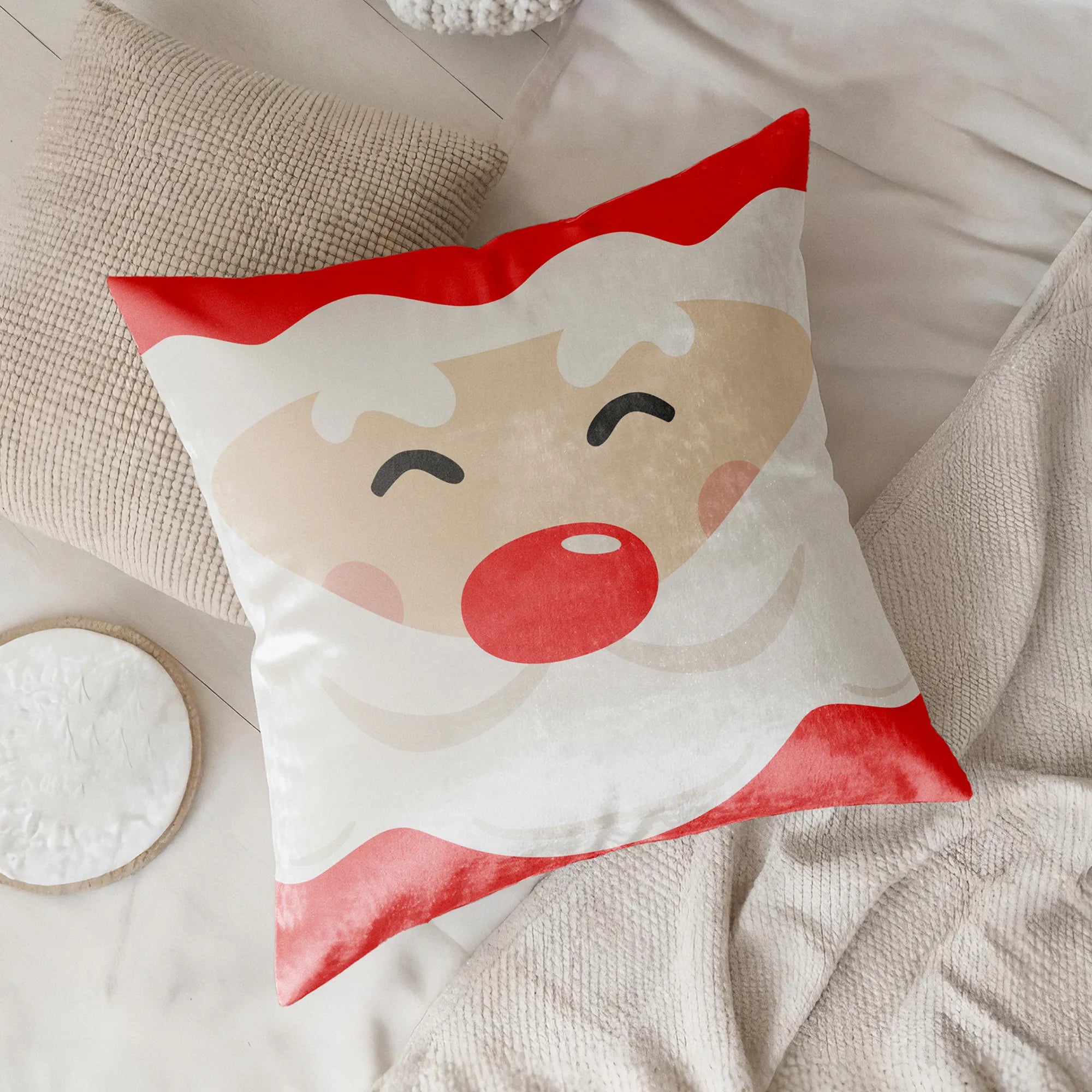 Decorative pillow with a santa's face design on a neutral background by Buffalo Bunny.