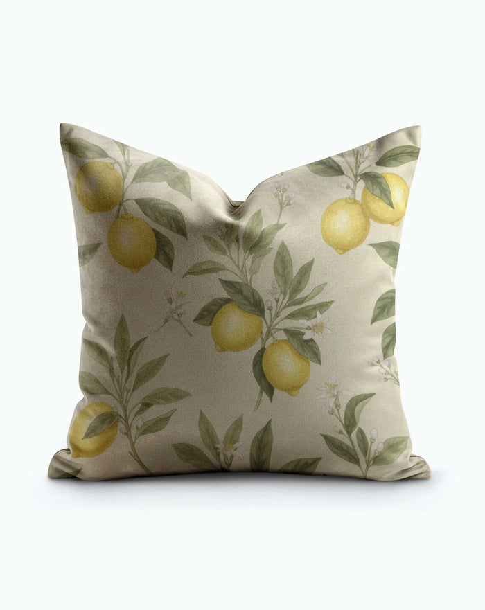 Mediterranean Lemon Grove Throw Pillow with yellow lemons, green leaves, and white blooms on warm taupe