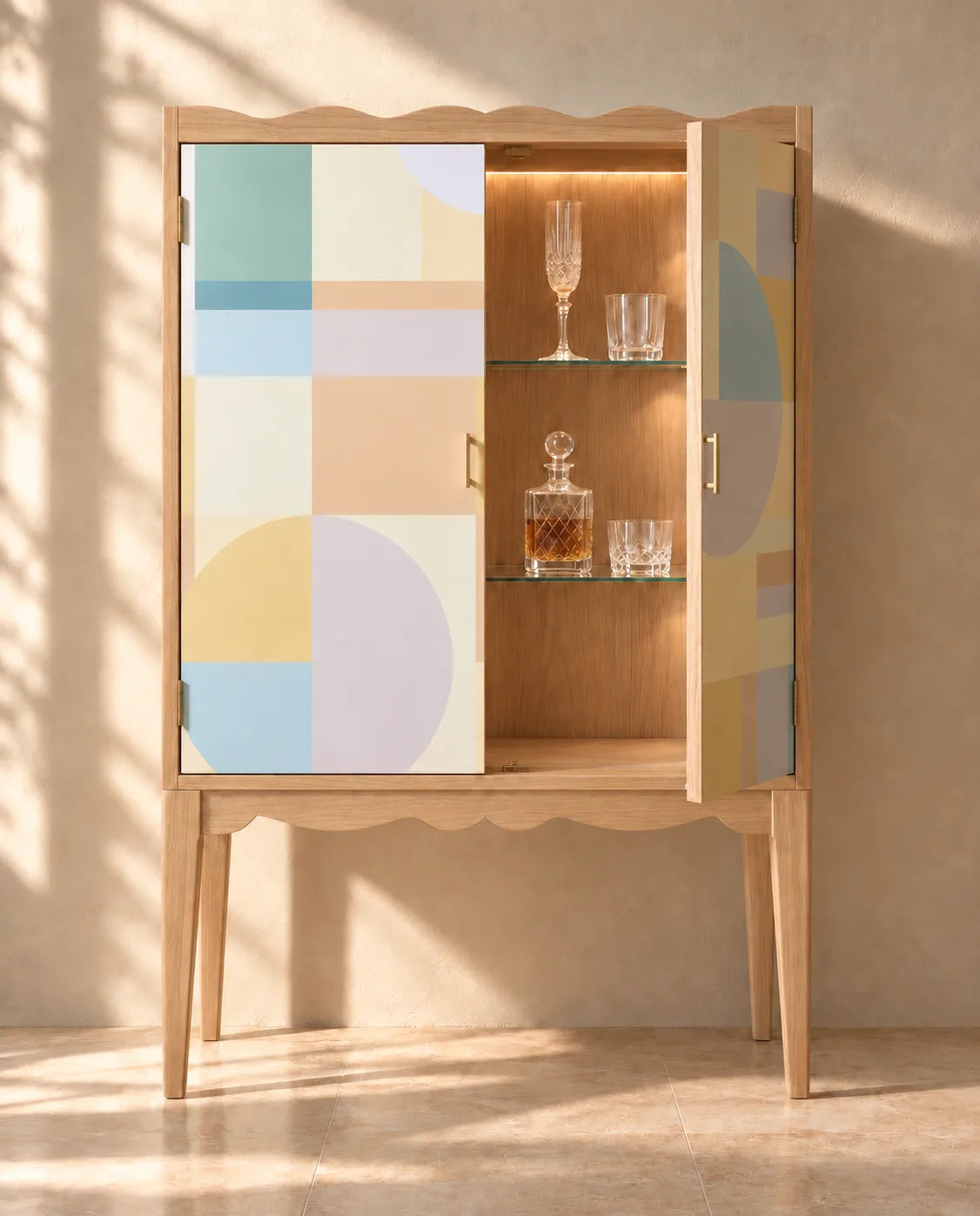 Pastel Modernist Mural Wallpaper lining a wooden drinks cabinet with pastel geometric blocks and circles