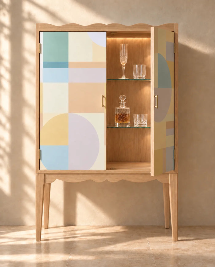 Pastel Modernist Mural Wallpaper lining a wooden drinks cabinet with pastel geometric blocks and circles